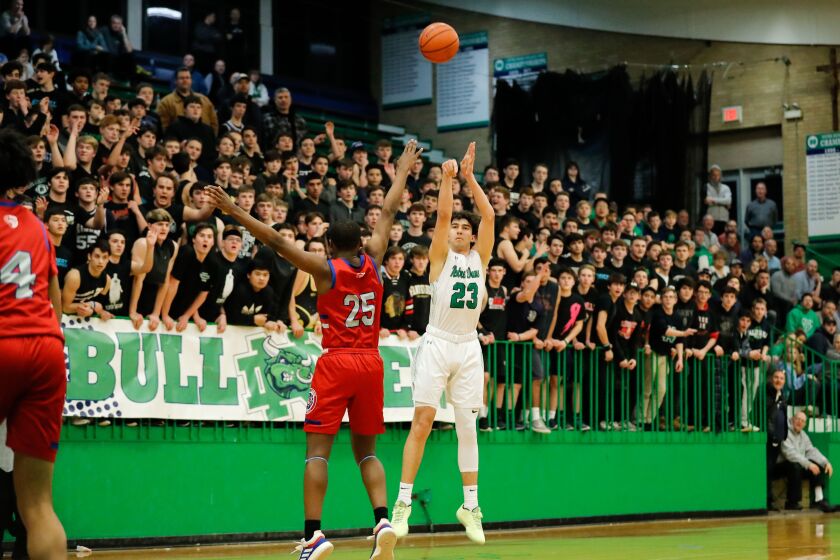 Notre Dame’s Louis Lesmond (23) shoots the ball over Curie’s Armond Williams (25).