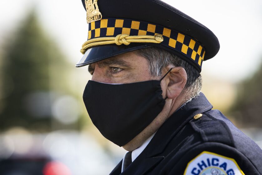 A Chicago Police Department sergeant wears a face mask and gets emotional while standing on West Lawrence Avenue, as only family members were permitted inside Cumberland Funeral Chapels for Chicago Police Officer Marco DiFranco’s funeral, Thursday, April 9, 2020.