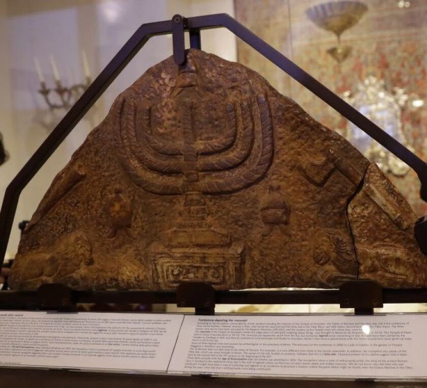 A bas-relief showing a menorah is part of a new Rome exhibit focusing on the menorah, the candelabra depicted in both Jewish and Catholic art over the centuries. (AP Photo/Alessandra Tarantino)