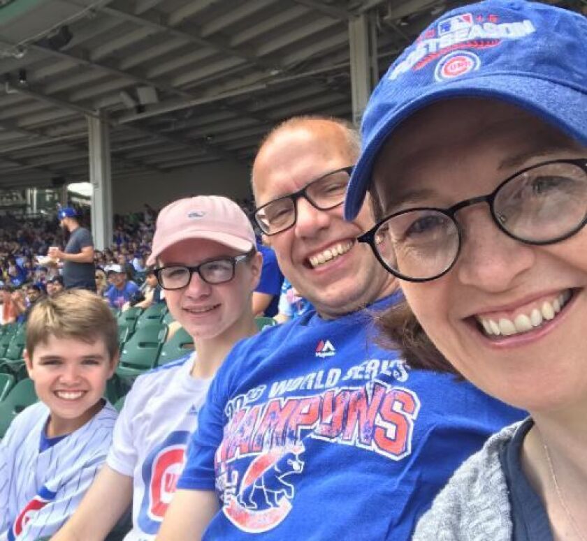 Julia Lynch (right) with husband John and two of their sons, used 325,000 miles to book five plane tickets for a baseball-themed family vacation. Canceling proved trickier.