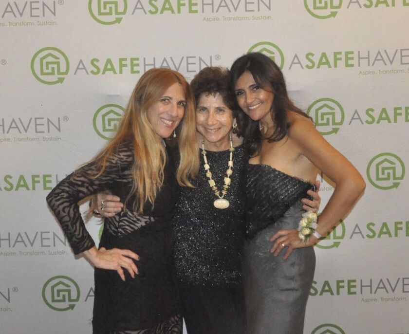 Mensch stands in between Orman Wiess and A Safe Haven CEO Neli Vazquez Rowland with Linda at a foundation gala. 