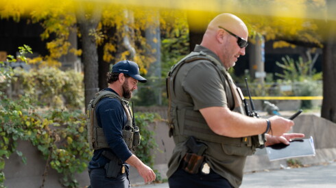 FBI officials investigate the scene Tuesday, following a shooting the evening before.