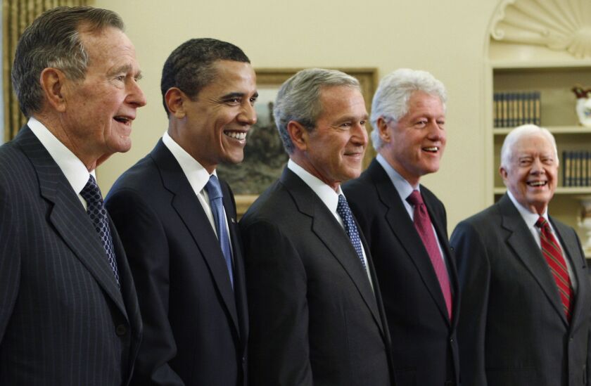 President George W. Bush, center, with President-elect Barack Obama, second left, and former Presidents George H.W. Bush, far left; Bill Clinton, second right; and Jimmy Carter, far right, in the Oval Office of the White House in Washington in January 200