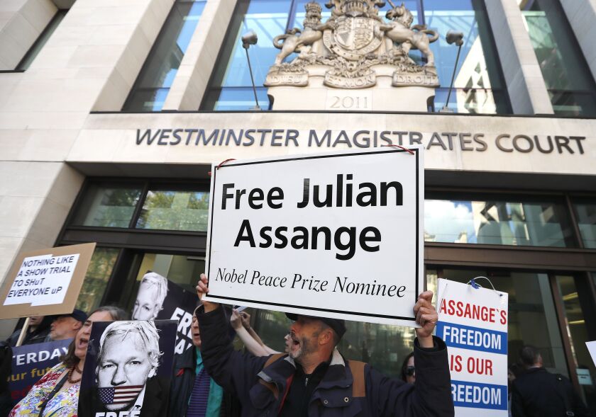 Protestors demonstrate at the entrance of Westminster Magistrates Court in London, Thursday, May 2, 2019, where WikiLeaks founder Julian Assange is expected to appear by video link from prison. Assange is facing a court hearing over a U.S. request to extr