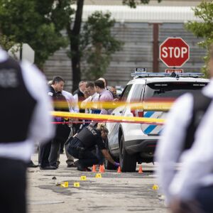 Chicago Police investigate at the 25th District station, 5555 W. Grand Ave., on the Northwest Side, after multiple officers were shot outside the station, Thursday morning, July 30, 2020. The suspect was also shot multiple times in the incident.
