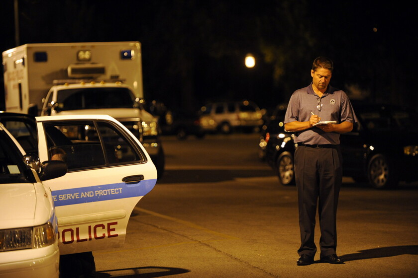 Investigative reporter Frank Main takes notes at a homicide scene in the 2900 block of West Palmer Avenue in Palmer Square on the Northwest Side, July 15, 2009. The story would be part of a larger package, published in 2010, documenting violence in Chicago neighborhoods.