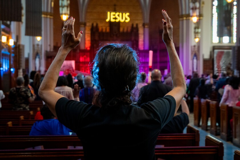 Do Congregant Raises Her Hands in Prayer During Sunday Service at St. Sabina Church, at 1210 W. 78TH pl., On Sunday, June 1, 2025.