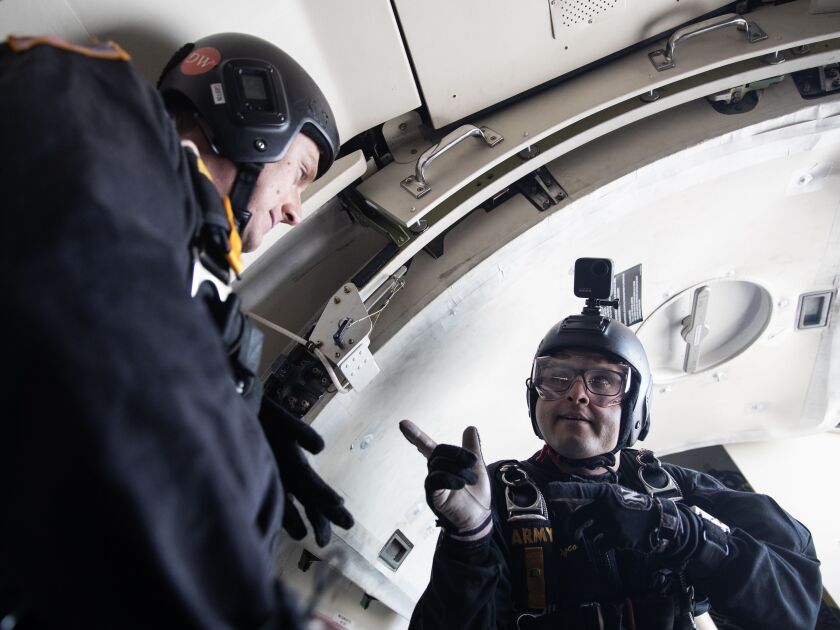 U.S. Army Golden Knights Staff Sgt. Nickolas Orzoco points to Staff Sgt. Griffin Mueller before jumping out of the plane Friday to practice for the 2023 Chicago Air and Water Show.