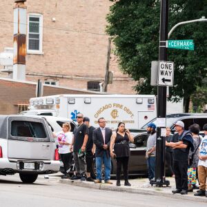 Family and friends of the Little Village fire victims, as well as media, stand outside Our Lady Of Tepeyac church as the hearses carrying the victims drive away on September 1, 2018. | Max Herman/For the Sun-Times