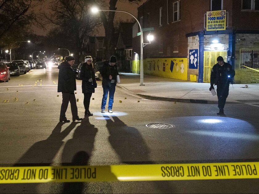 Chicago police investigate a scene where three people where wounded in a shooting Friday night in the 3400 block of West Ohio Street. | Tyler LaRiviere/Sun-Times