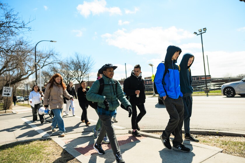 A group of students walk to protest near their school.