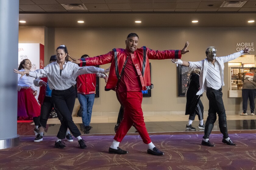 Members of Chicago flash mob dancing group Chicago Thriller dance to Michael Jackson’s iconic songs in the lobby of AMC Roosevelt Collection 16 during the opening of “Michael" on Friday.