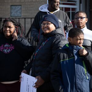 Volunteers and the siblings of Andrea Stoudemire; Brincy Johnson (center), Peter Brwon (bottom right), and Michael Johnson (right) during an early Christmas Eve event to surprise Stoudemire’s children.