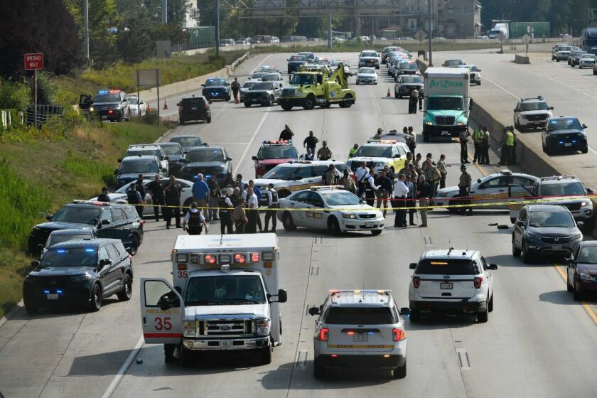 Police investigate on the Dan Ryan Expressway at 43rd Street where a state trooper was shot Friday, Oct. 1.