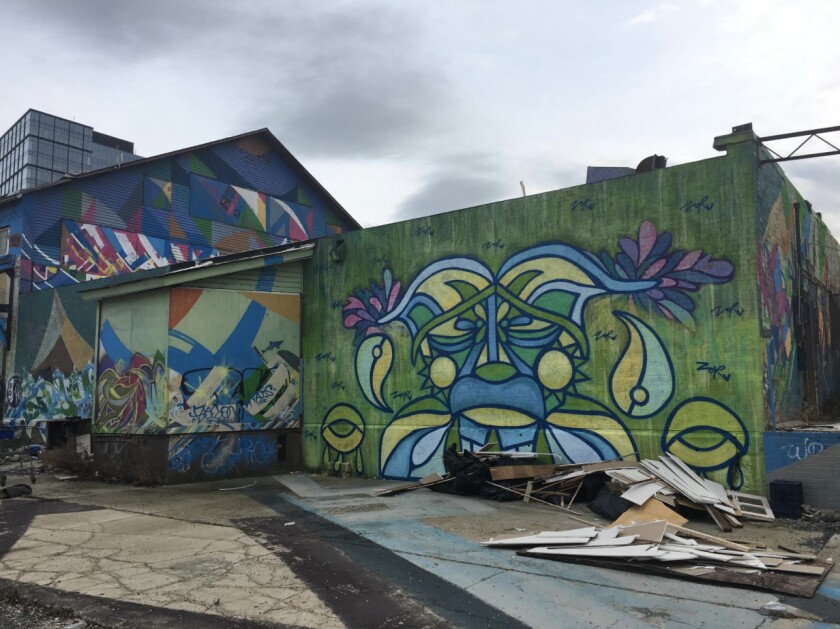ZorZorZor’s mural near Fulton Market uses her signature line work to create a large character.