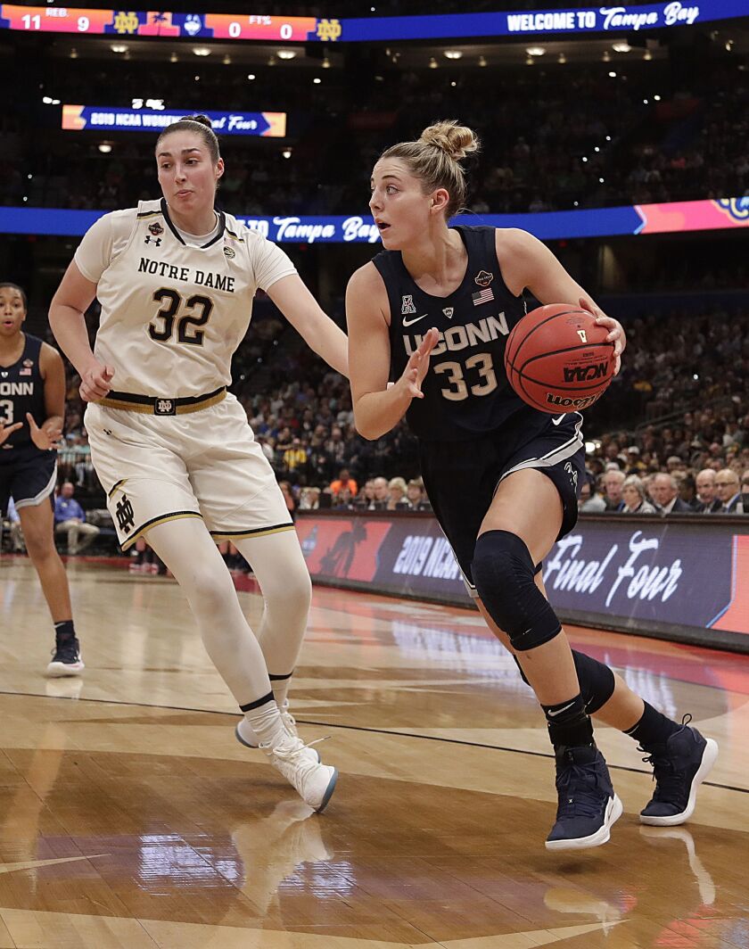 Connecticut guard Katie Lou Samuelson (33) looks to pass as Notre Dame forward Jessica Shepard (32) defends during the first half of a women’s Final Four NCAA college basketball semifinal tournament game, Friday, April 5, 2019, in Tampa, Fla. | John Raoux