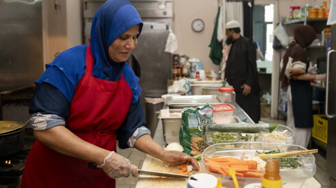 Toyuba Amir Ali, owner of Asian Homecook, prepares food at her restaurant in West Ridge.
