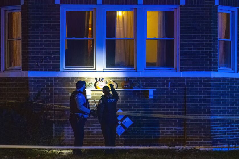Chicago police work the scene where multiple people were shot in the 9300 block of South Racine Avenue in Washington Heights.