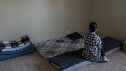 Shaknoza kneeling on a mattress