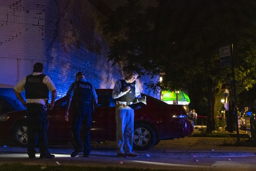 Chicago police work the scene where at least 8 people were shot in the 6300 block of South Artesian Ave in the Marquette Park neighborhood, Sunday, June 27, 2021.