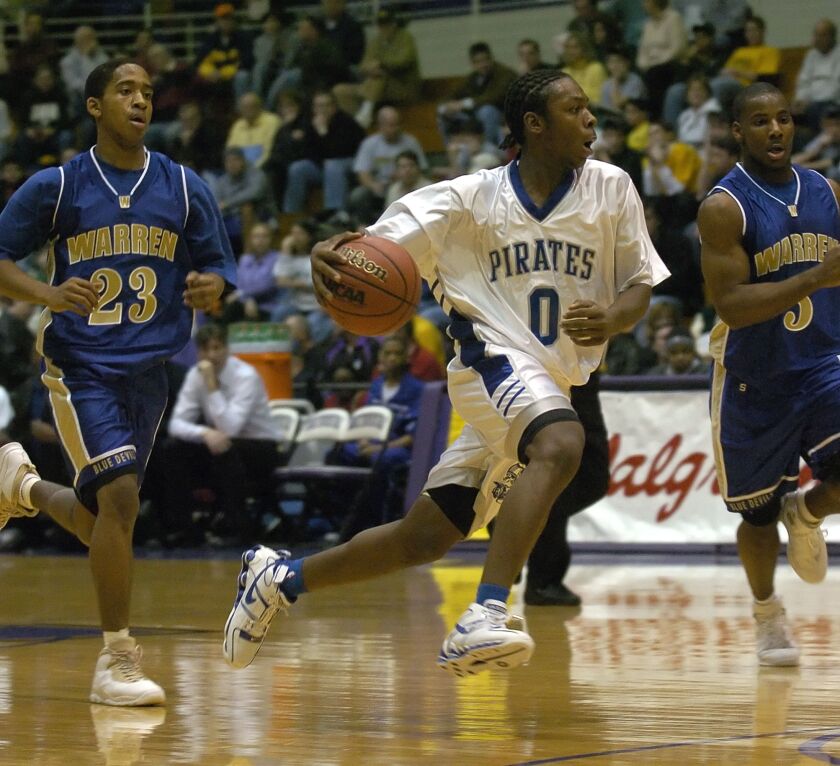 Jacob Pullen moves the ball against Warren defenders Ceola Clark and Marvin Bembry in 2006.