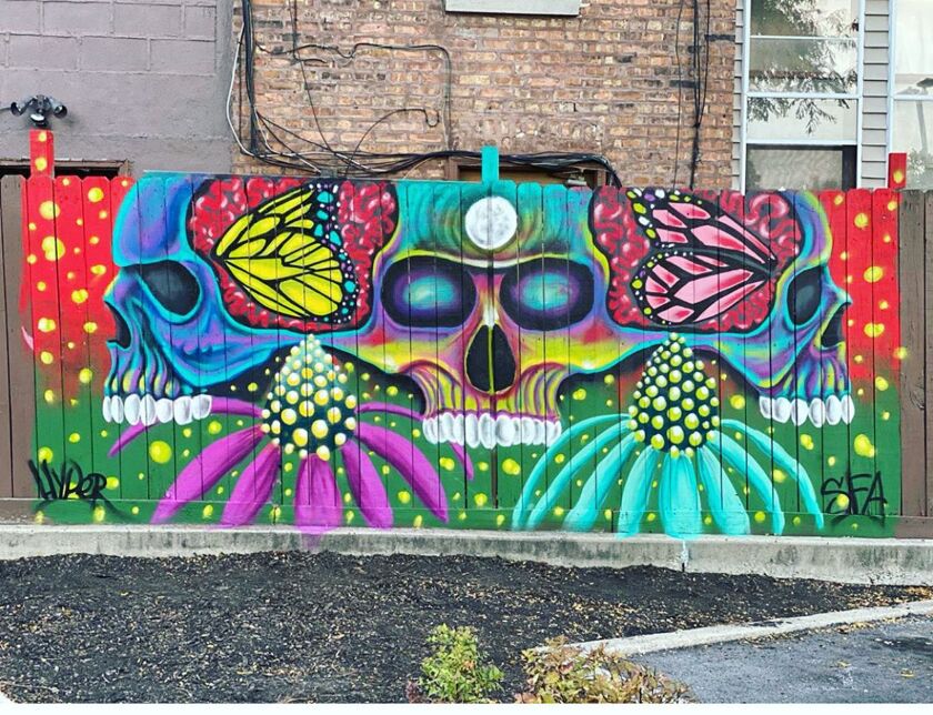 This work by Mario Mena, head of the Gage Park Mural Project, combines butterfly wings and traditional Mexican skull imagery in a display of reds and greens.