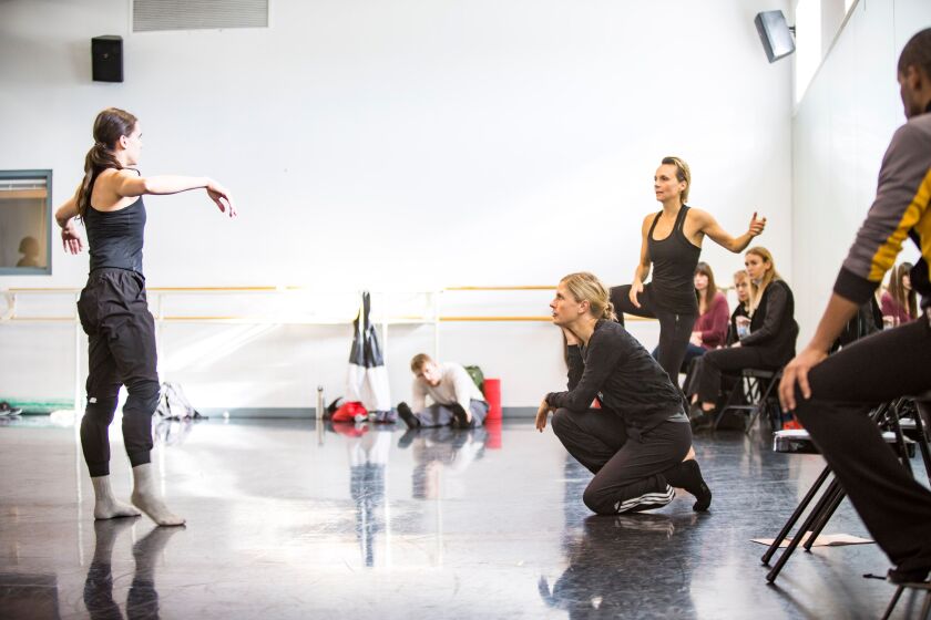 Choreographer Crystal Pite (kneeling) homes in on Jacqueline Burnett during rehearsal with Hubbard Street Dance Chicago. | James Foster/for the Sun-Times