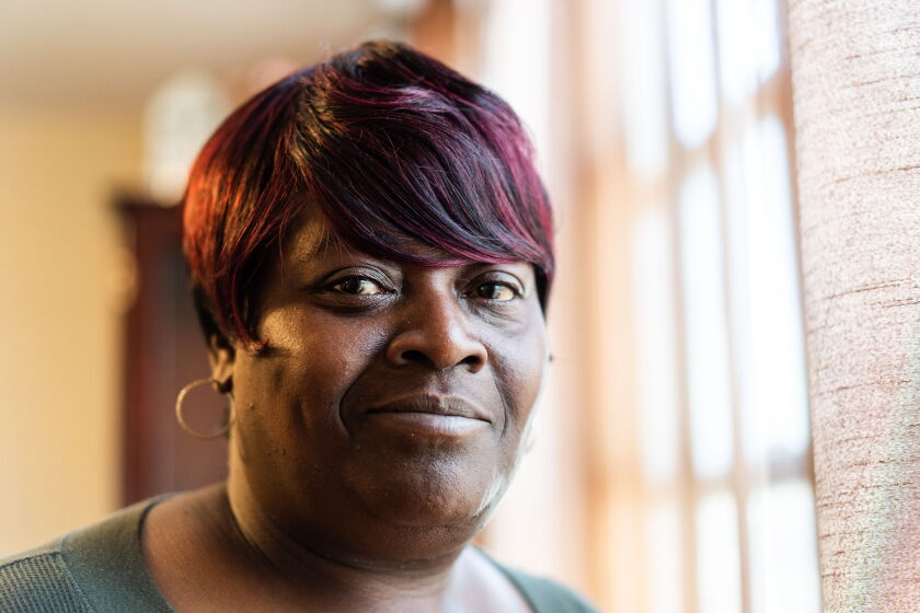 Gail Goodwin, 57, who receives $500 a month from the Chicago Resilient Communities guaranteed income program, stands in her dining room in the Chicago Lawn neighborhood.