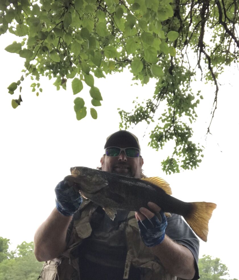 Ken “Husker” O’Malley with a Kankakee River smallmouth bass. Provided photo