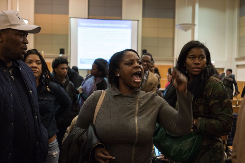 Erica Brown, a mother of two Harper High School students, urges Chicago Public Schools officials not to close Englewood’s four high schools durinjg a hearing Jan. 10 at Kennedy-King College. | Max Herman / Sun-Times