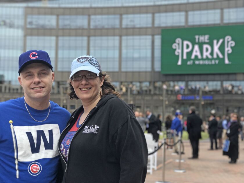 Edward Savitzky, 41, and his wife Bernadette Savitzky,42, attend the ribbon-cutting ceremony of the new plaza outside Wrigley Field. Bernadette called the recent development in the area around Wrigley a “grownup’s Disneyland” or “Cubbieland.” | Andrea Sal