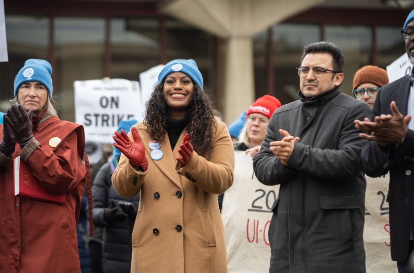 Chicago Teachers Union President Stacy Davis Gates claps while standing beside Ald. Byron Sigcho-Lopez (25th) during a UIC Faculty United union strike at the University of Illinois Chicago.