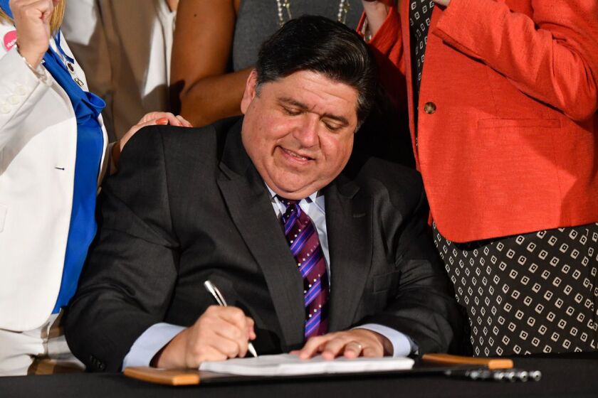 Gov. J.B. Pritzker signs a bill at the at Chicago Cultural Center in 2019.