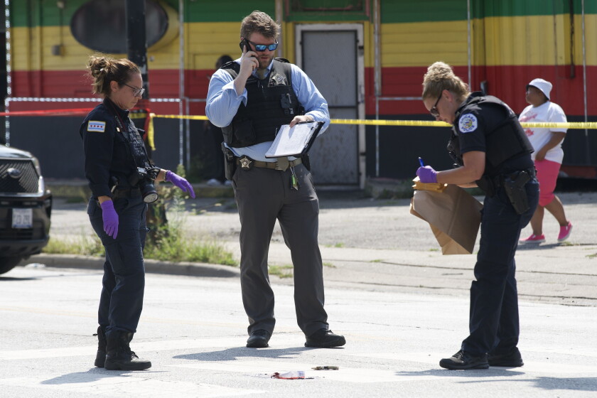 Chicago police investigate a shooting Wednesday in the 200 block of South Pulaski Road in West Garfield Park.