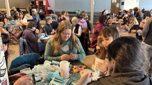 Minnesota residents put together whistle kits with zines and whistles delivered by Chicagoans at a whistle party in Columbia Heights, Minnesota, Jan. 17, 2026.