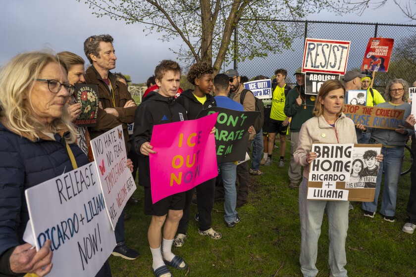 Kristy Morrow (right) and a group of others hold signs at rally for Ricardo.