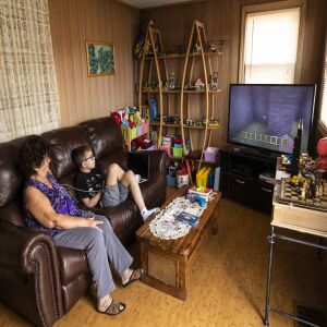 Danuta Kalinowska looks at her 12-year-old grandson Oliwier “Oli” Kluzik as he plays Minecraft at their Northwest Side home.