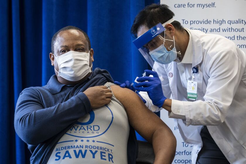 Ald. Roderick Sawyer (6th) receives his first dose of the Pfizer-BioNTech COVID-19 vaccine Monday at St. Bernard Hospital on the South Side.