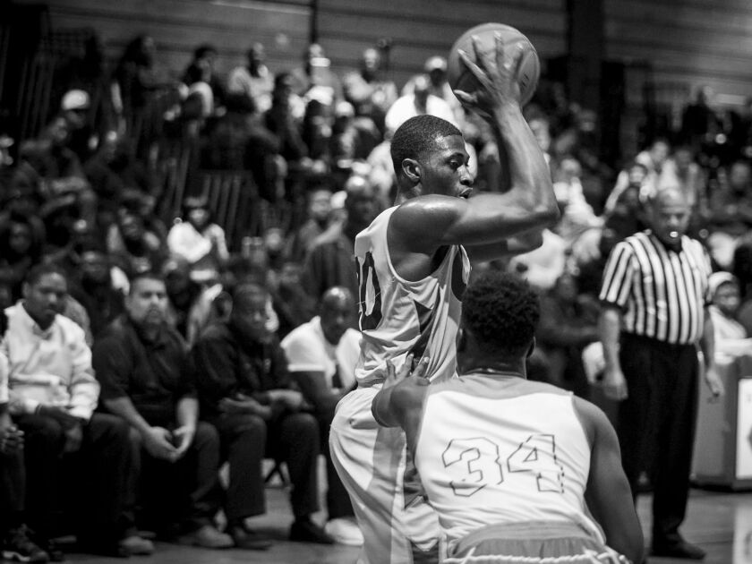 Orr Academy High School’s Raekwon Drake looks for an open teammate during an away game against Curie Metropolitan High School, Feb. 15, 2017.