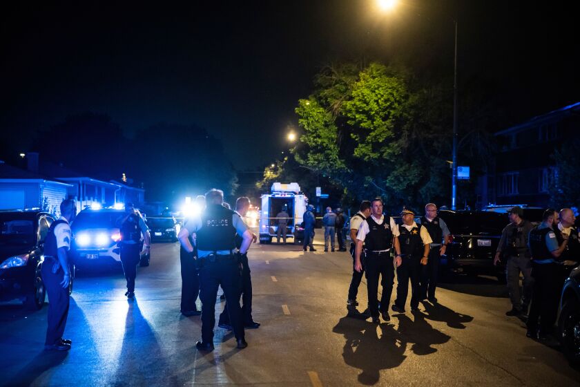 Chicago police and SWAT officers investigate in the 4400 block of West Walton Street where an alleged gunman barricaded himself in a building after one man was killed and three other people were wounded in a shooting Sunday night in West Humboldt Park on the West Side. The suspect also suffered a gunshot wound in the incident, thought to be domestic, but officers didn’t fire any shots, police said.