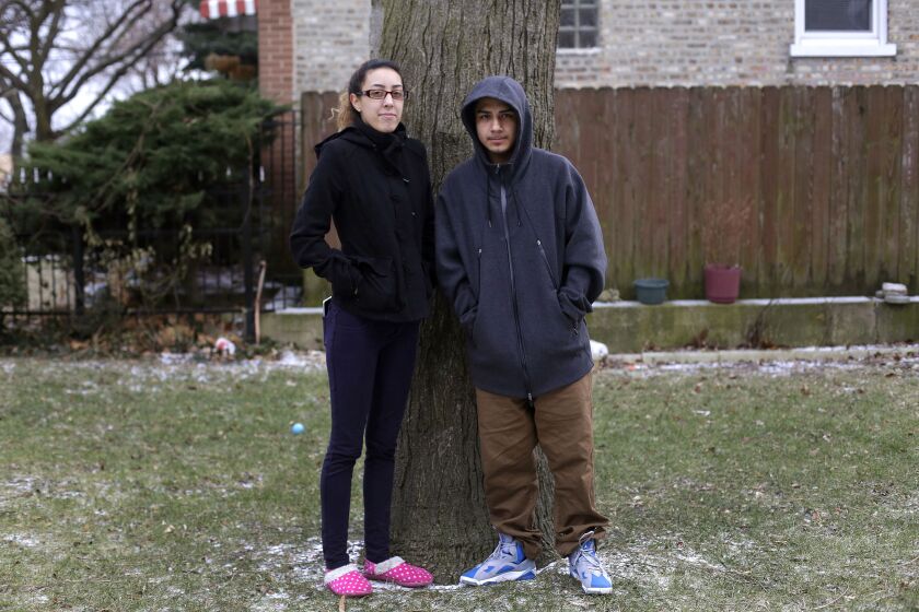 A young couple, Anna and Luis, say count on CeaseFire violence interrupters. “Most of us don’t have parents, so they are like our parents,” Anna says. | Joshua Lott / The Trace