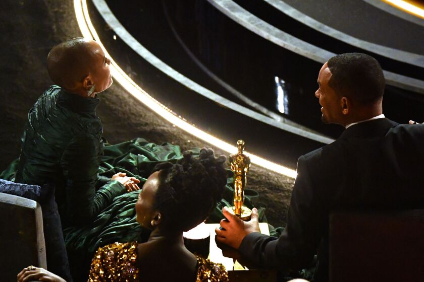 Will Smith sits alongside his wife, actress Jada Pinkett Smith, with the award for Best Actor in a Leading Role for “King Richard” during the 94th Oscars at the Dolby Theatre in Hollywood, California, on Sunday, March 27, 2022.