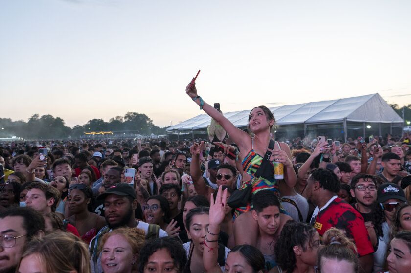 A girl takes a selfie as City Girls performs on day two of the Summer Smash Festival.