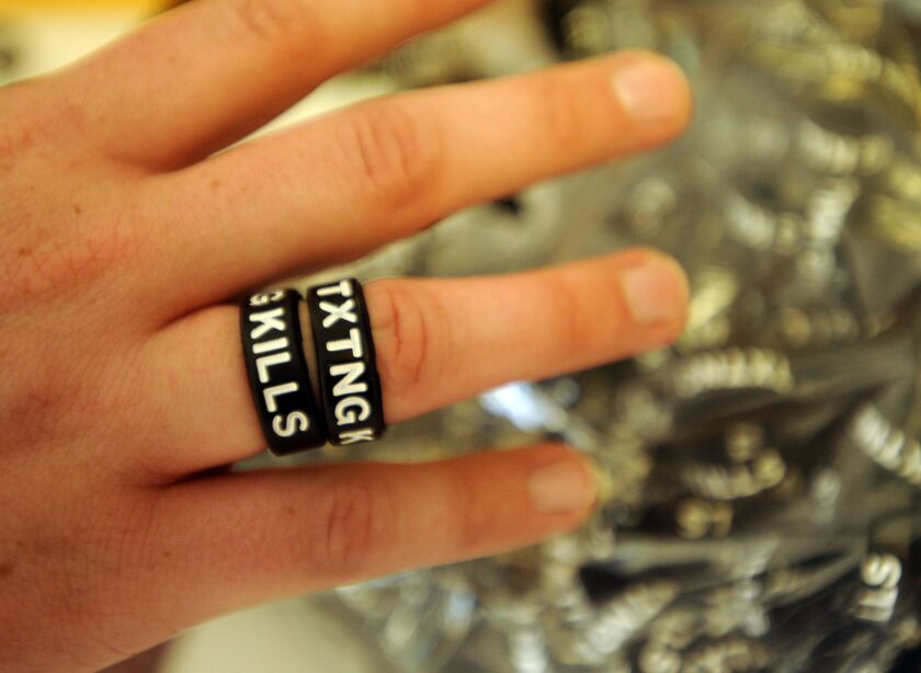 Various approaches, including these rings handed out at a suburban Chicago high school, have been tried urge younger drivers to refrain from unsafe practices behind the wheel. | Sun-Times file photo