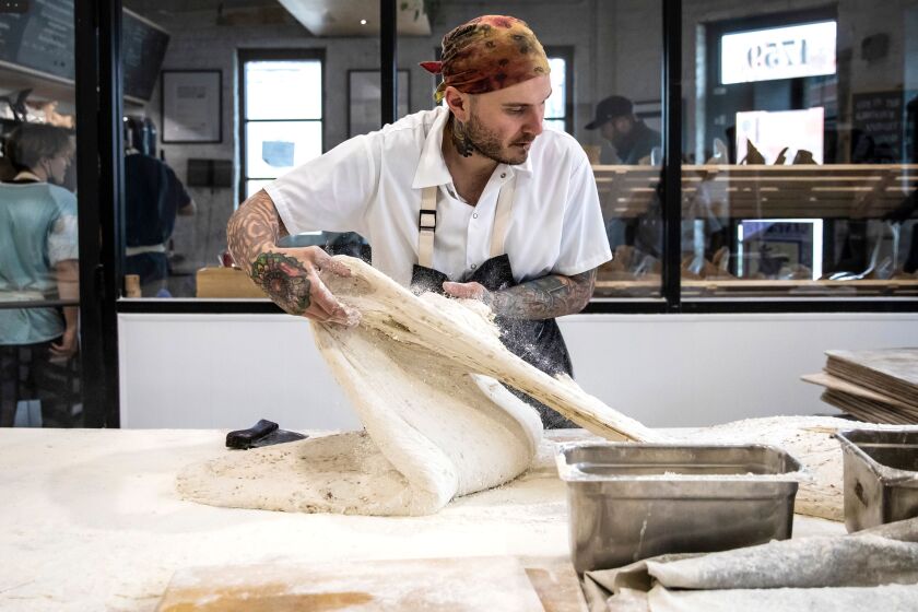 Chef Greg Wade portions honey oak porridge dough at Publican Quality Bread at 1759 W. Grand Ave. in West Town.