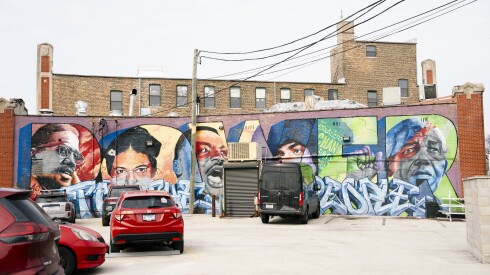 A mural shows Chicago native Jennifer Hudson along with Malcolm X, Rosa Parks and the Rev. Martin Luther King Jr. on the back of a building.