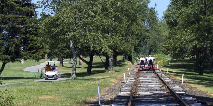A Rail Explorers tour passes through the grounds for the Montaup Country Club in Portsmouth, R.I. Rail Explorers opened in Portsmouth in April as part of the Newport and Narragansett Bay Railroad. | AP Photo/Jennifer McDermott