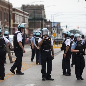 Chicago Police Cmdr. Ernest Cato (center), flanked by other officers, responds to reports of looting and rioting near West Madison Street and South Karlov Avenue on the West Side, Monday afternoon, Aug. 10, 2020.