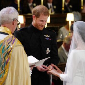 Prince Harry places the wedding ring on the finger of Meghan Markle during their wedding ceremony. | JONATHAN BRADY/AFP/Getty Images