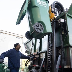 Carlos Strickland, a truck driver for Block Bins, loads compost bins behind Mariano’s in Oak Lawn.